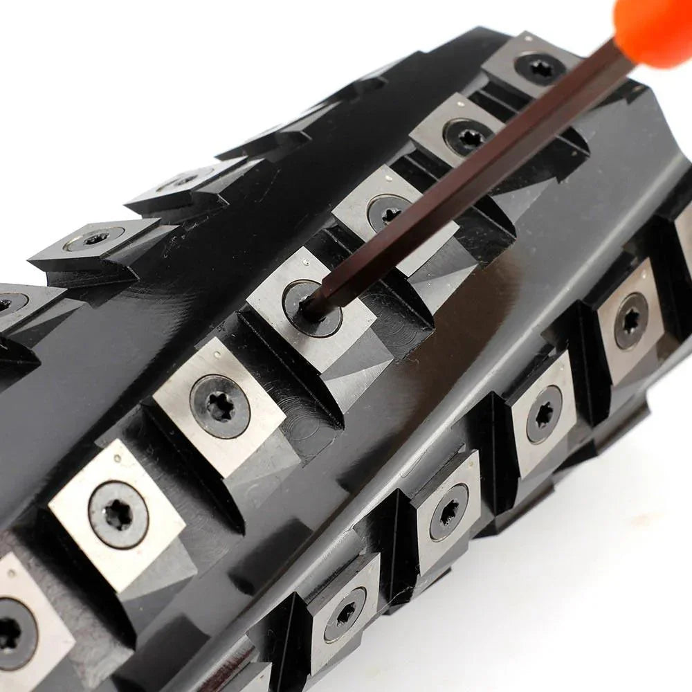 Precision metal cutting tool with replaceable carbide inserts and screwdriver adjustment