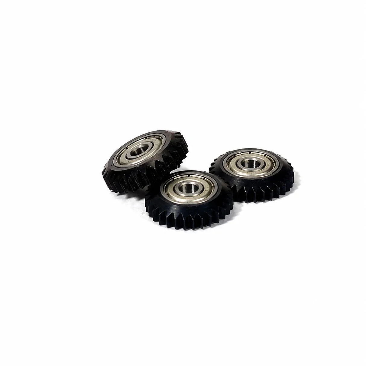 Three black gear wheels with metal bearings for woodworking tools