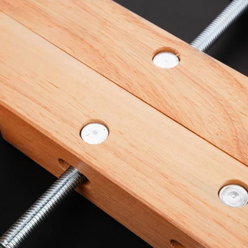 Woodworking clamp with hardwood jaws and metal threaded rods for secure project holding
